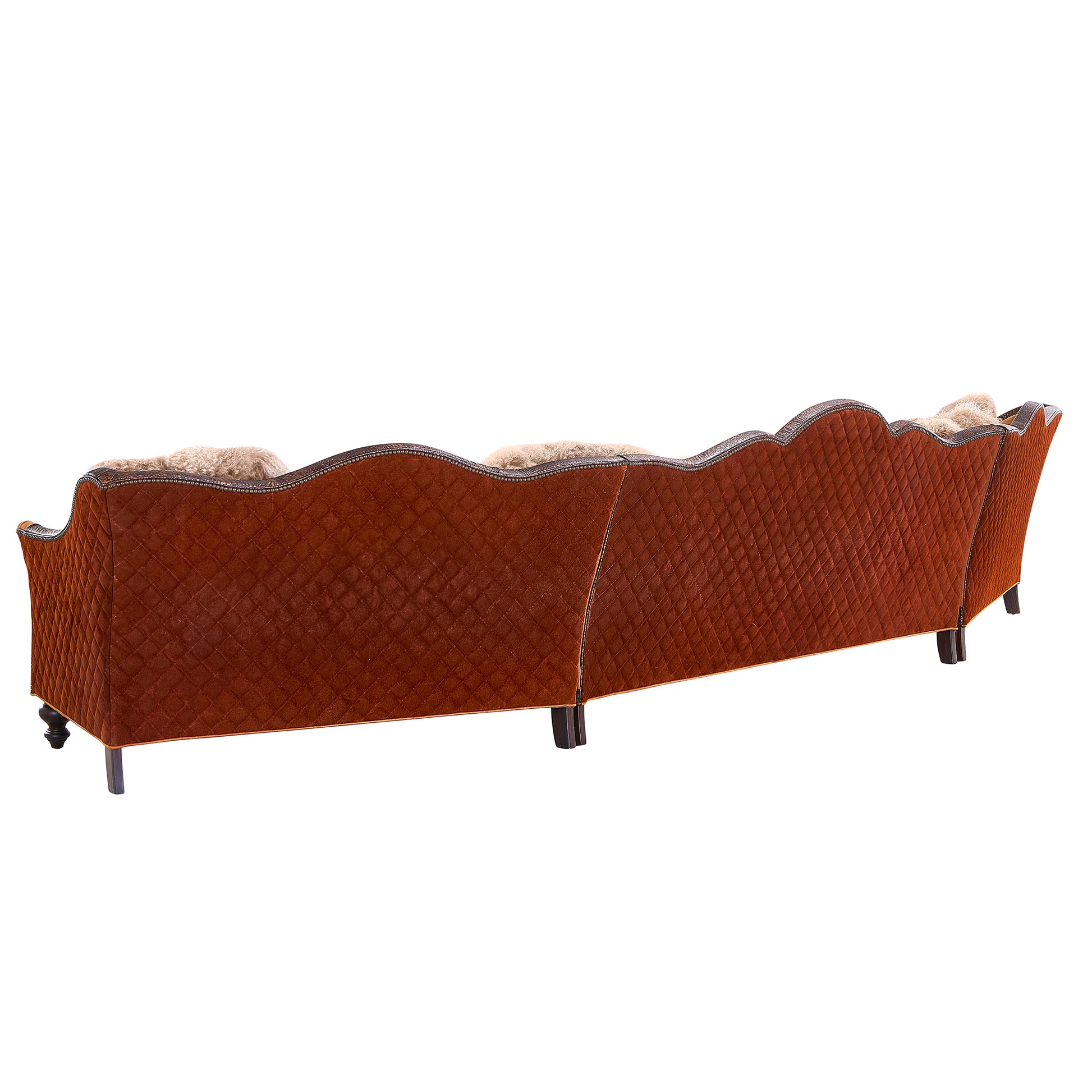 Back view of the Red Rock Mountain sectional showing embossed leather panels, hand-applied nailhead trim, and detailed quilting across the frame
